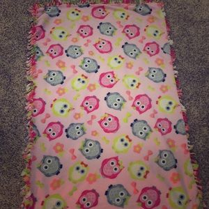 Pink blanket with owls and polka dots on it